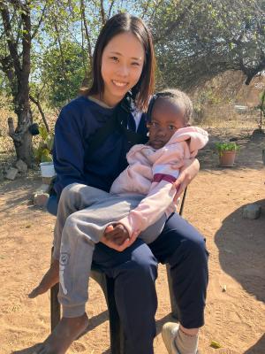 Volunteer with a child in the Centre Photo